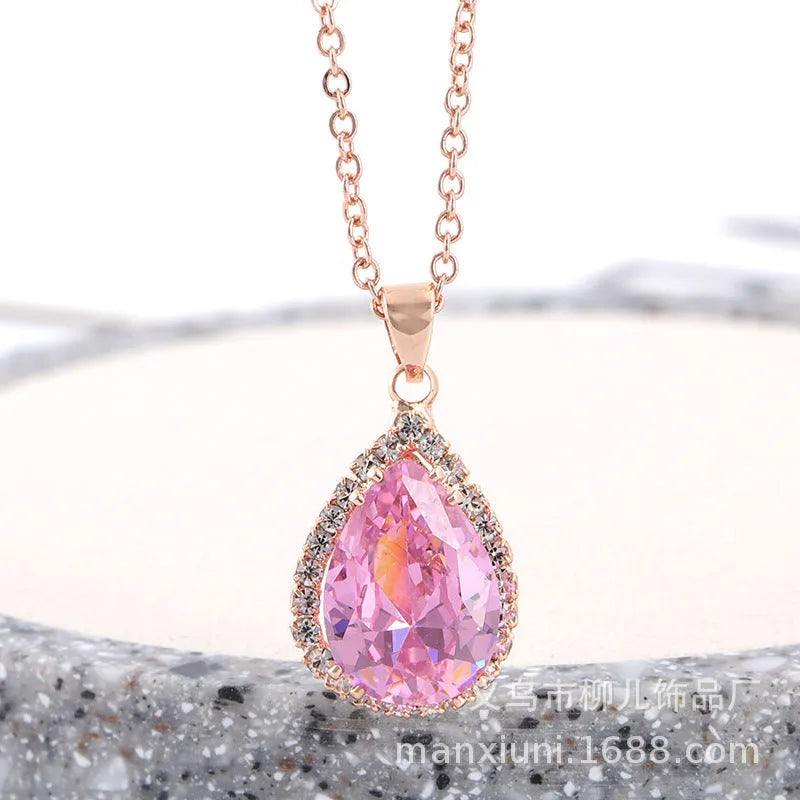 Pink water drop shaped rhinestone necklace with rose gold electroplated alloy pendant on white background