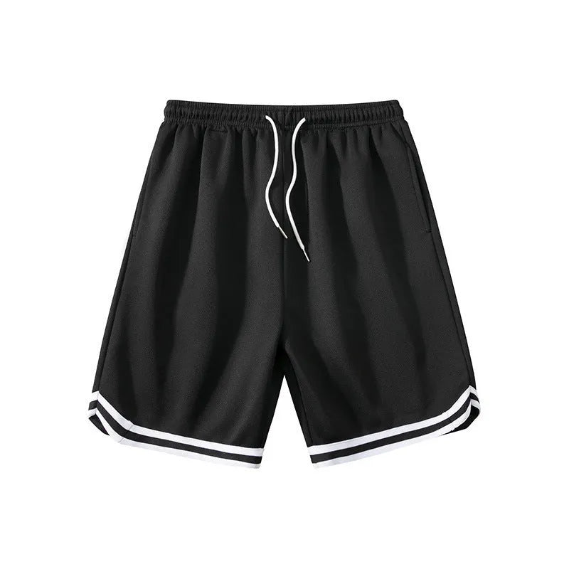 Man wearing loose grey sports shorts made from elastic polyester fabric.