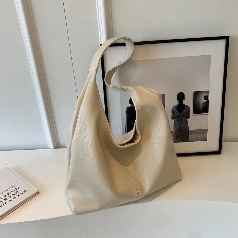Casual soft PU leather large capacity shoulder bag in street trend style.
