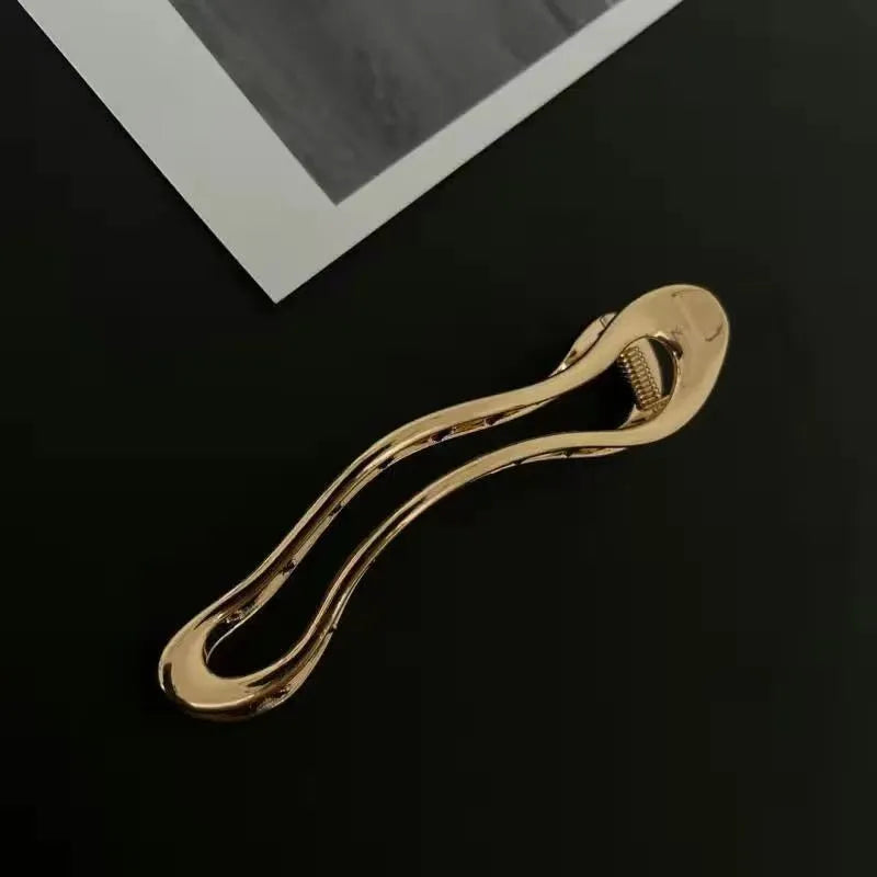 Women's zinc alloy hair barrettes in gold and silver with arc, square, and triangle shapes