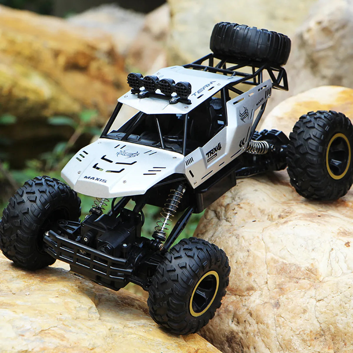 Black and silver remote control climbing cars with 2.4G wireless controller on a rough surface.