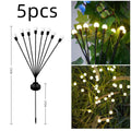 Solar-powered LED ground spike garden light with multiple heads and stainless steel soil plug.