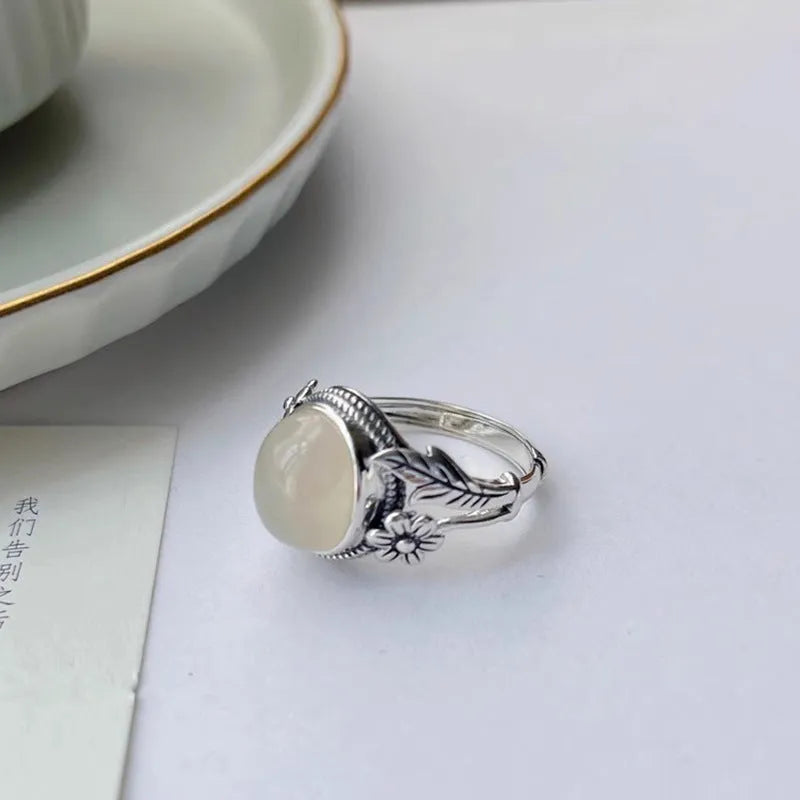 Adjustable vintage-style copper ring with white chalcedony finish showing open mouth design