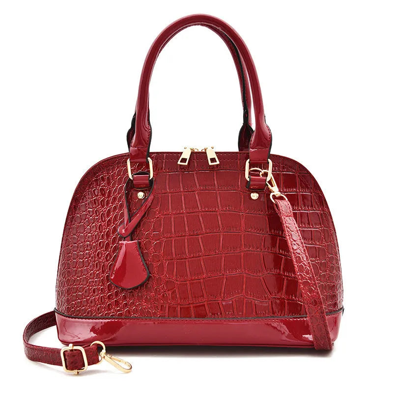Shiny PU leather crossbody shoulder bag in structured shell shape design showing black colour option