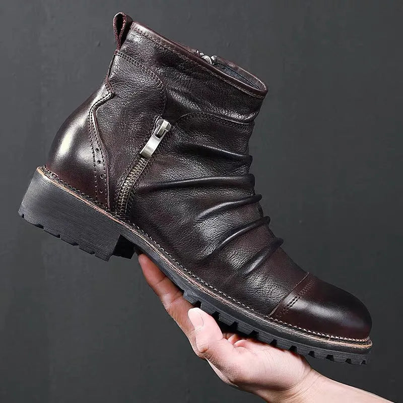 Black side zip Martin boots with round toe and medium heel on a plain background.