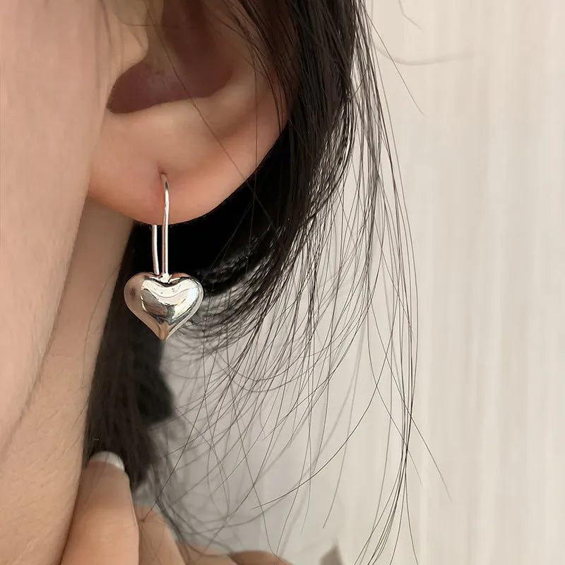 Three-dimensional glossy heart-shaped earrings with white gold colour finish and Korean-style design