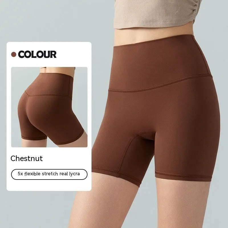 Women's high waist Lycra yoga shorts in leaf green, shown in a yoga pose.