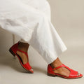 Red women's sandals with square buckle closure and herringbone toe holder design