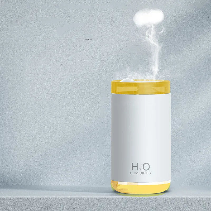 Blue jellyfish humidifier on a table emitting smoke ring mist with warm night light glow