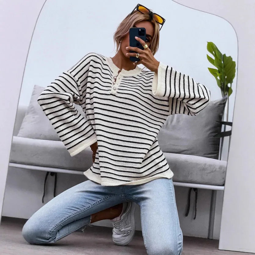 Black striped women's loose top with drop shoulders and button detail on viscose knit fabric