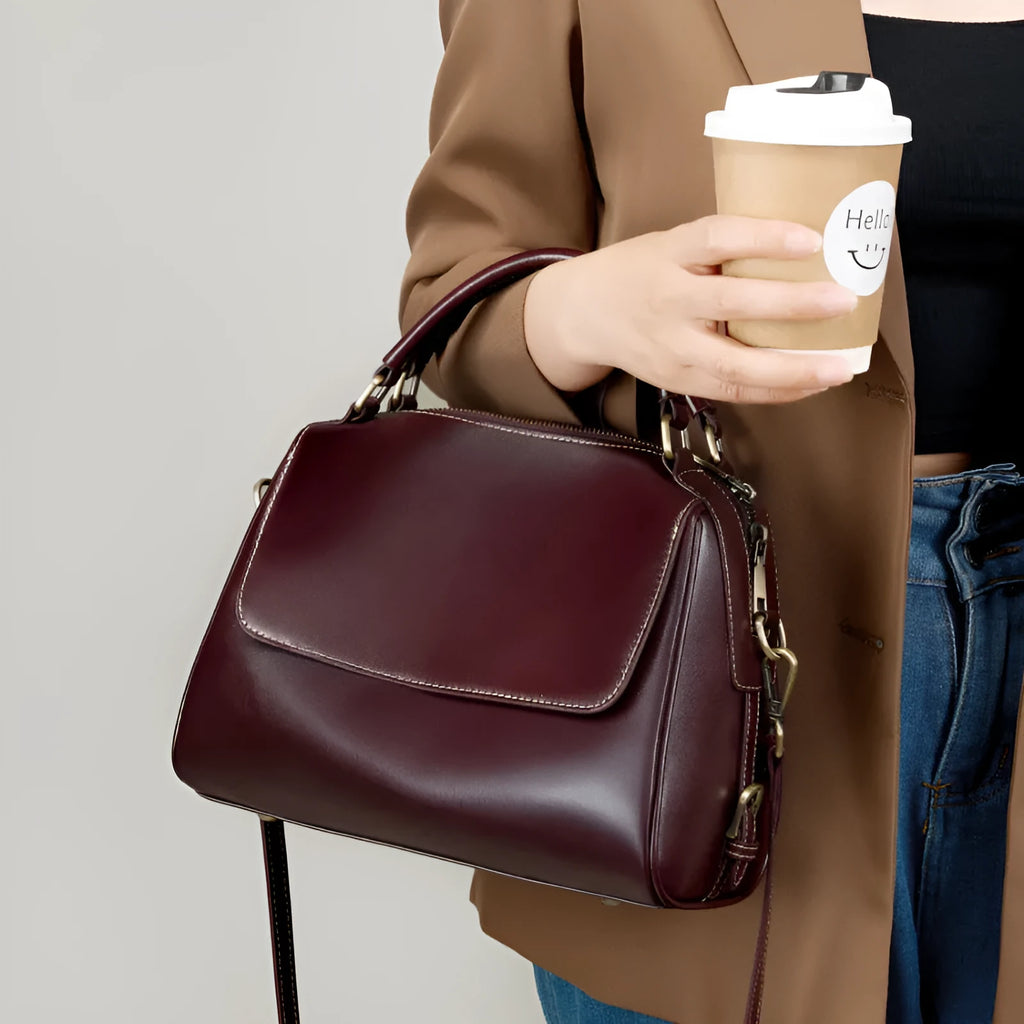 Women's soft genuine leather crossbody tote bag in a square shape with a double strap, shown in apricot colour.