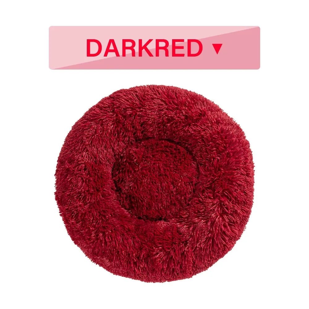 Fluffy donut-shaped pet bed in long plush fabric, shown in a light grey colour.