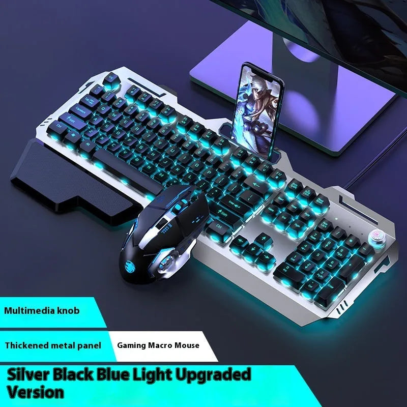 Aluminium gaming keyboard with volume knob, shown in metal grey with RGB lighting alongside optional macro mouse and headset.