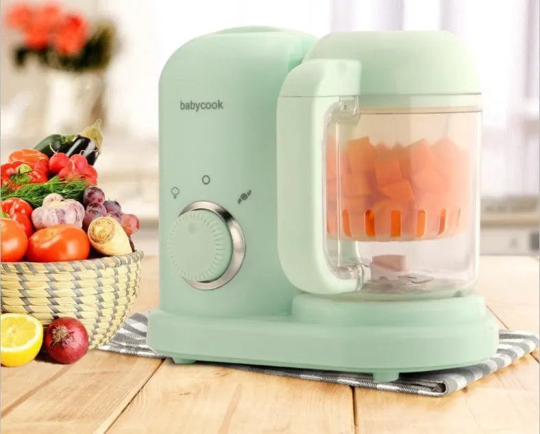 Baby food processor with steamer and blender functions in green or pink, showing dual mixing blades