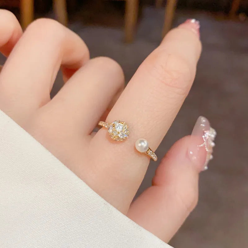 Gold plated open-end ring with round zircon accents on a geometric copper band