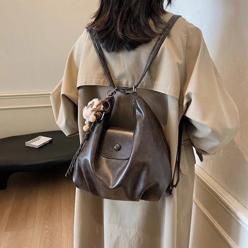 Women's PU leather commuter shoulder bag in horizontal square shape with single strap and optional pendant