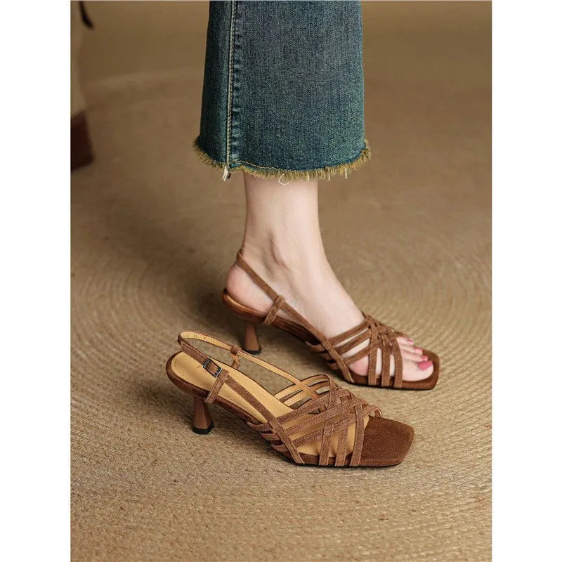 Women's light brown retro high heel sandals with thin cross straps and an ankle buckle on a square toe.