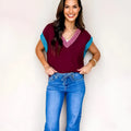 Burgundy women's loose sweater with V-neck contrast trim and cuffed short sleeves