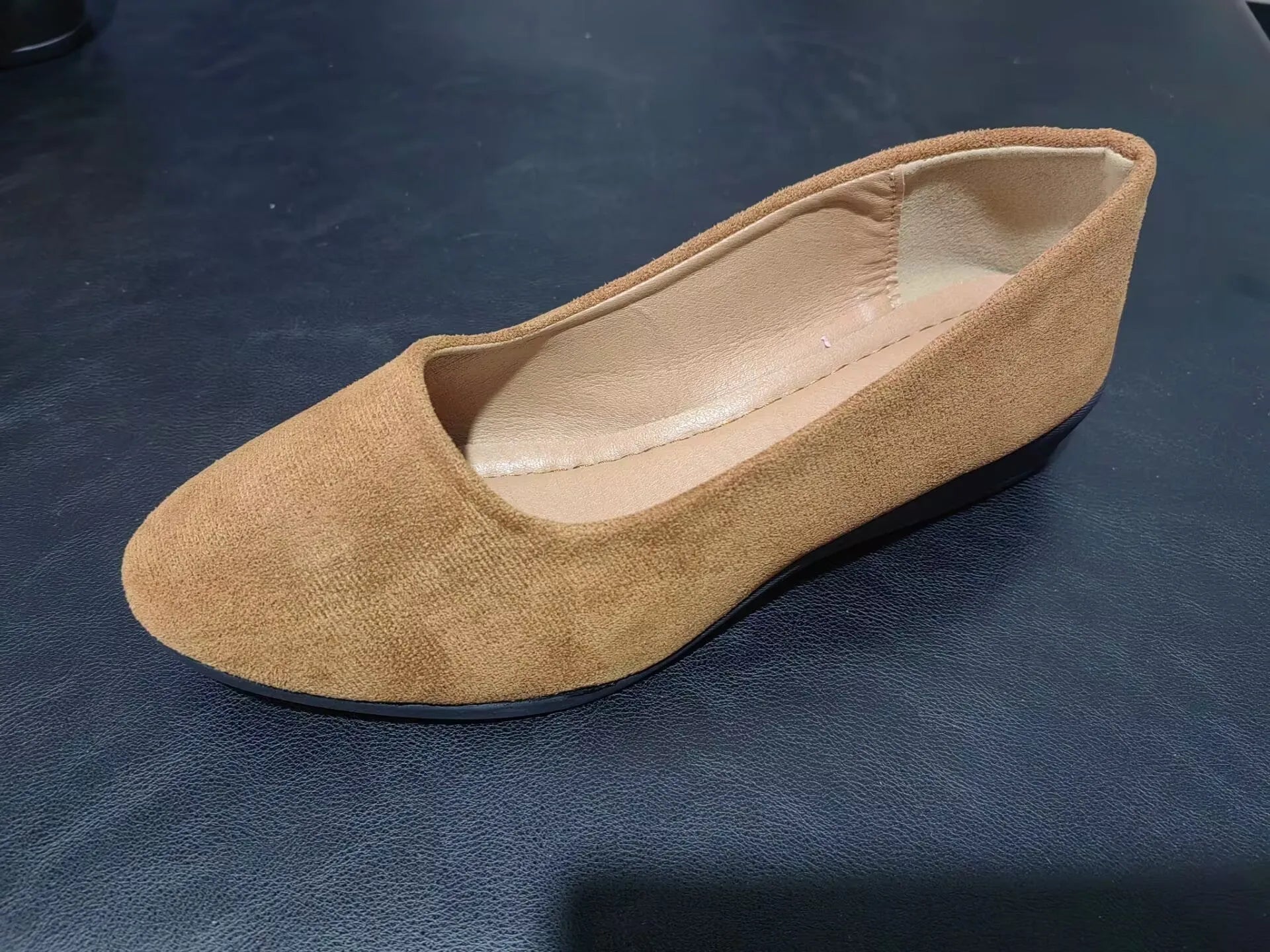 Women's pointed toe suede wedge pumps in light brown with a shallow mouth cut and low rubber sole.