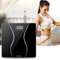 Black electronic digital bathroom scale on a tiled floor showing weight display.