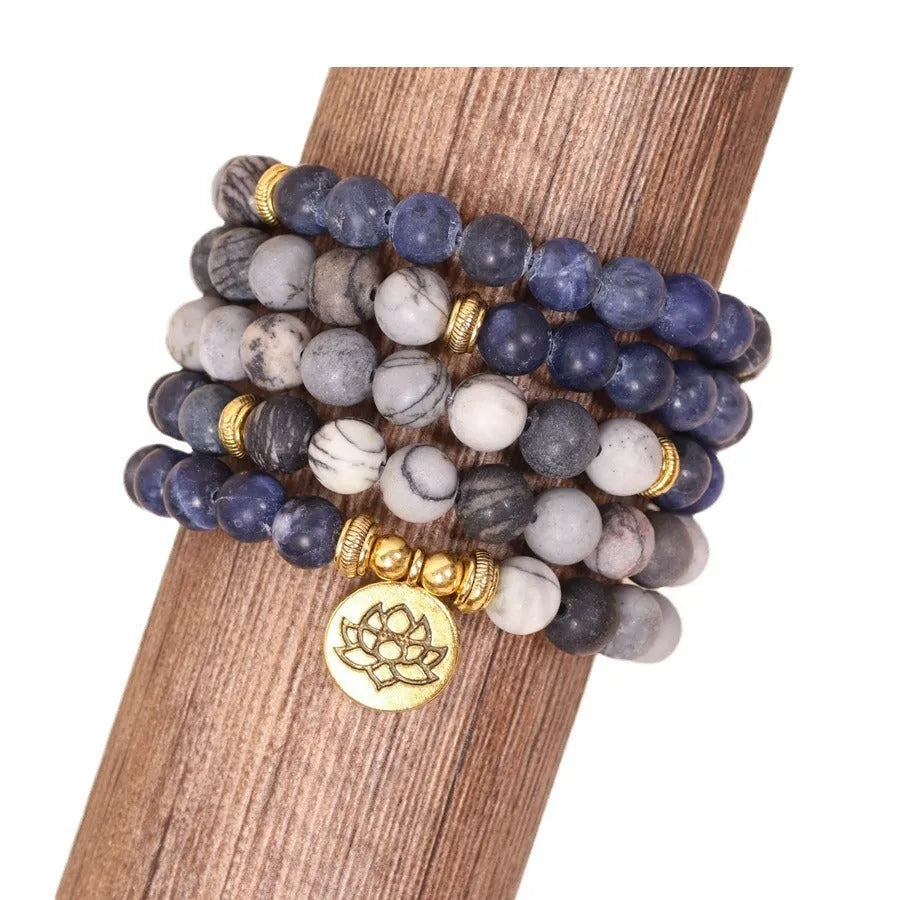 Close-up of a blue patterned network stone bead multi layer alloy bracelet on a wrist
