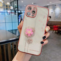 Green 3D flower design phone case with spin stand for iPhone, showing built-in screen protector.
