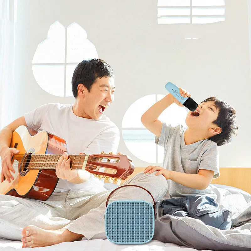 Small white portable Bluetooth speaker with a built-in microphone on a table.