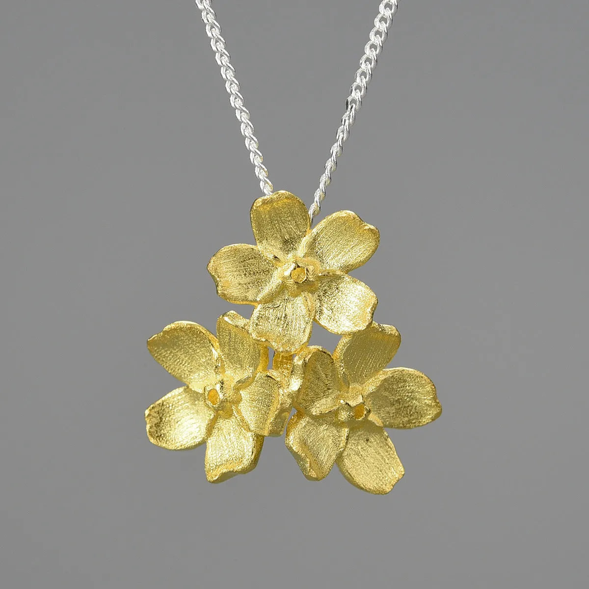 Myosotis Sylvatica sterling silver floral pendant in pastoral style, showing gold and silver colour options.