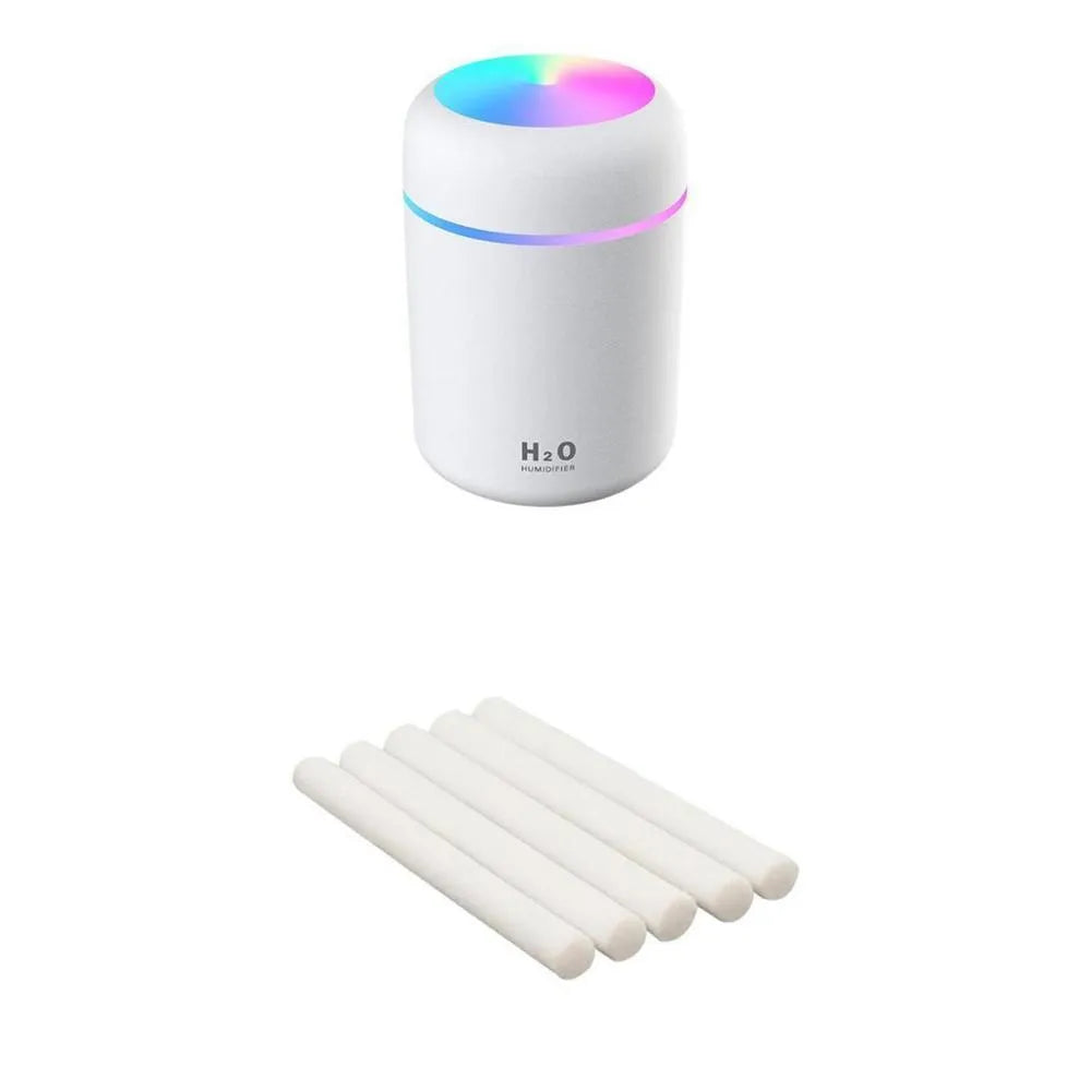 Pink USB mini humidifier with LED lights and water tank on desk