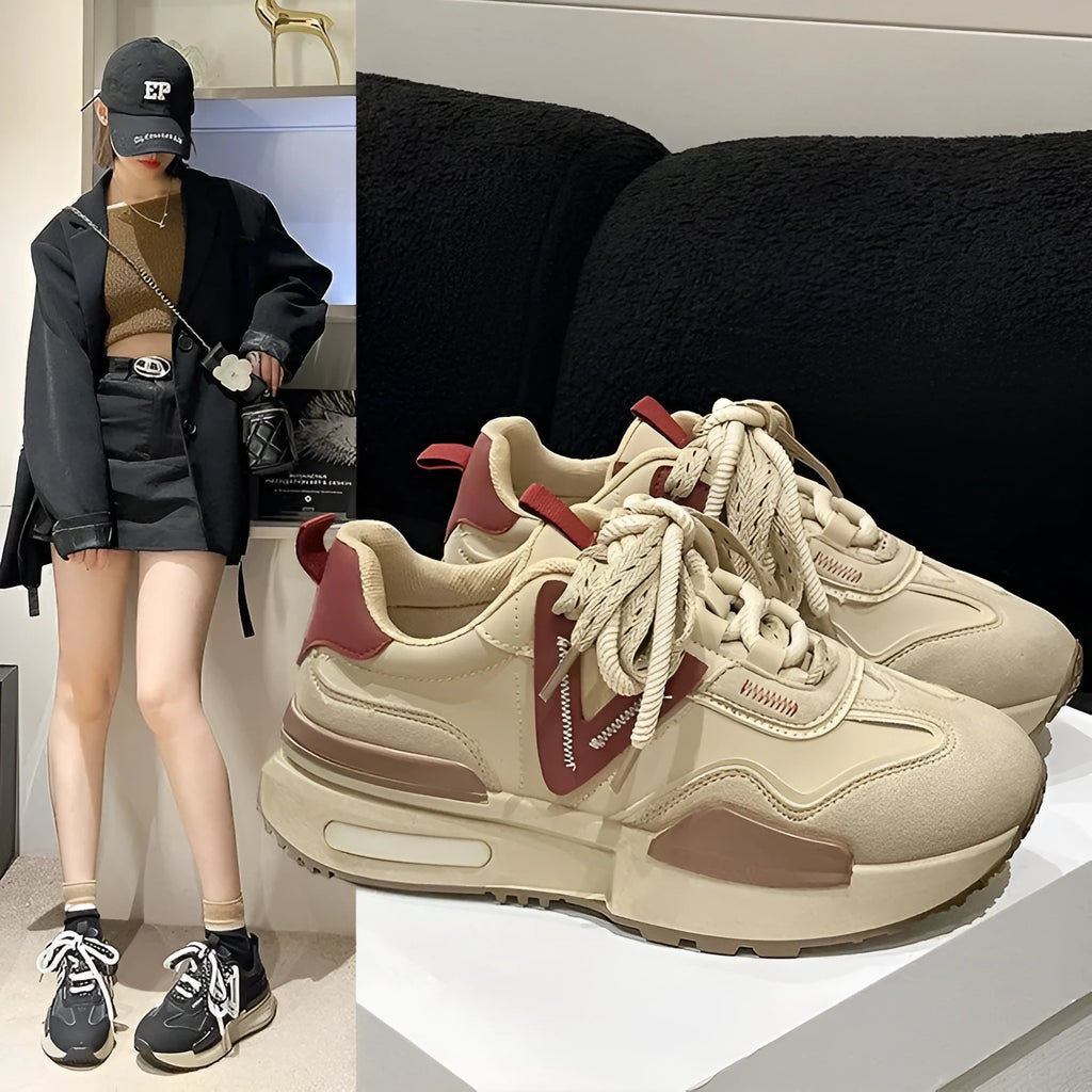 Women's retro platform sports shoes in black with mesh lining and rubber sole, shown from the side.