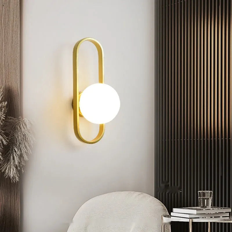 Minimalist wall lamp with glass shade and iron body in black or gold colour