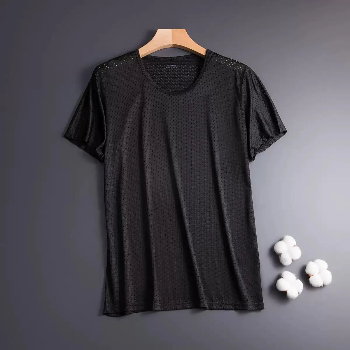 Man wearing a thin grey ice silk mesh short sleeve T-shirt with a crew neck.