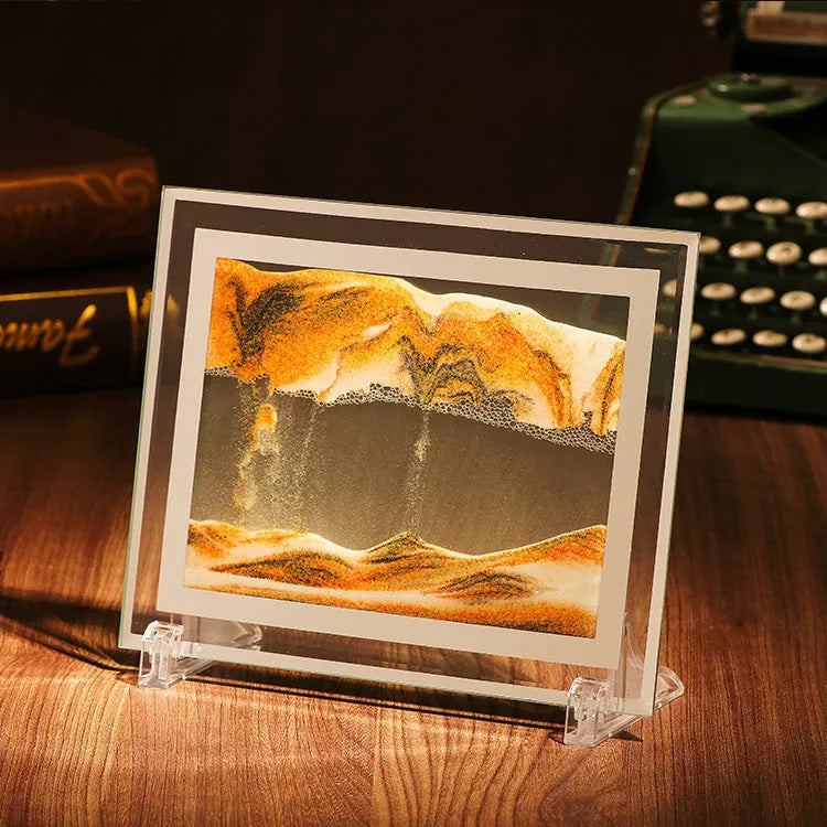 Glass quicksand painting ornament with geometric shape showing landscape sand art in black and white green colours.