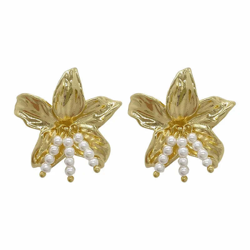 Golden H1795 metal earrings with detailed flower shape and exaggerated design elements