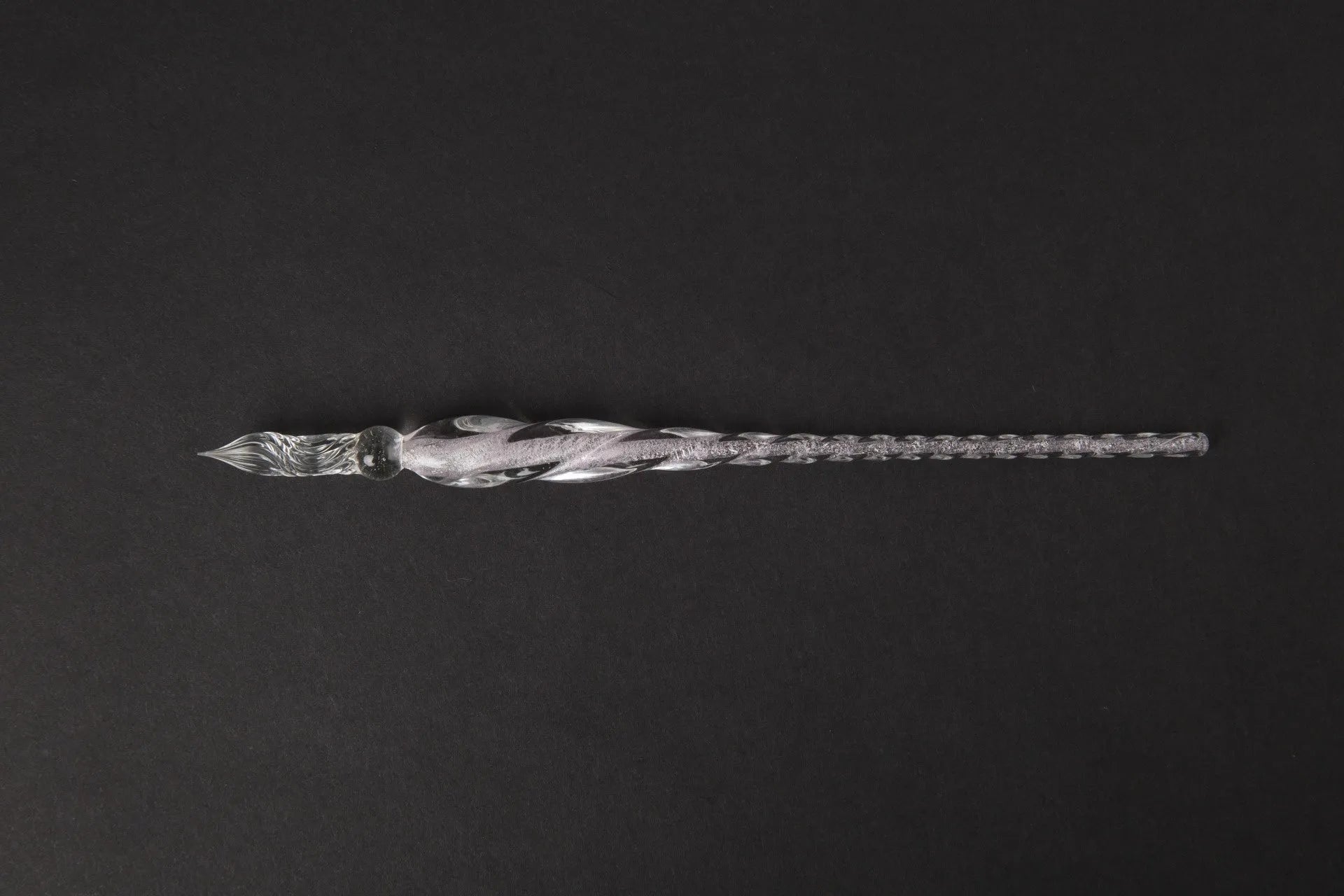 Transparent glass signature pen with coloured ink visible inside, abstract modelling, gift box packaging