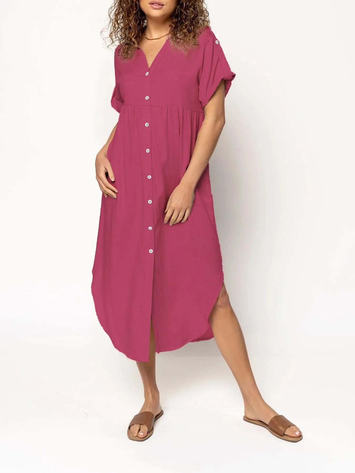 A woman wearing a casual solid-colour mid-length dress with a button-down front.