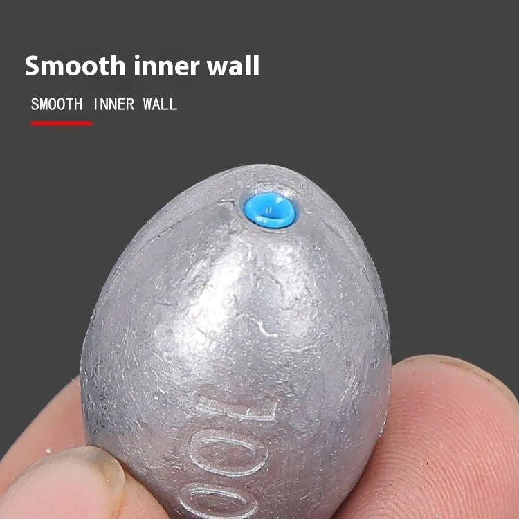 Olive green rugby-shaped fishing sinker with scale texture, showing plastic core construction and weight markings.