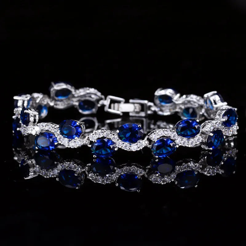 Geometric gold electroplated women's bracelet with inlaid zircon stones, shown in one of five colour options.