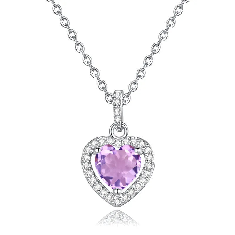 Women's sterling silver necklace with heart-shaped pendant containing natural gemstone on adjustable cross chain