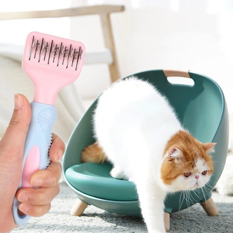 Pink pet grooming comb with stainless steel knot knife, massage brush head, and comb teeth on a white background.