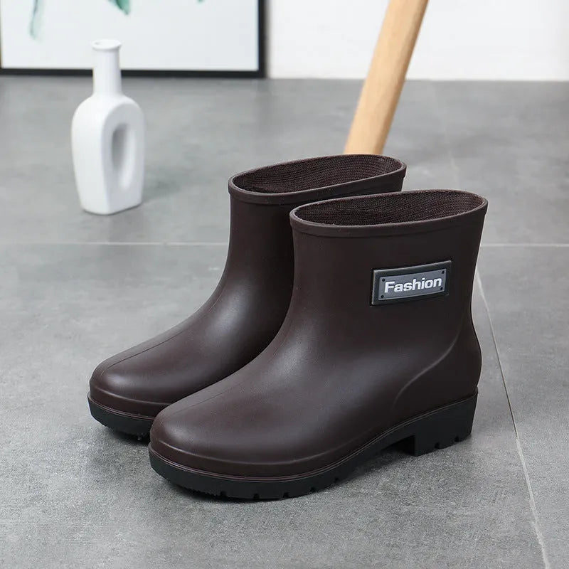 Women's mid-calf PVC rain boot in black, shown with a low heel and optional wool lining.