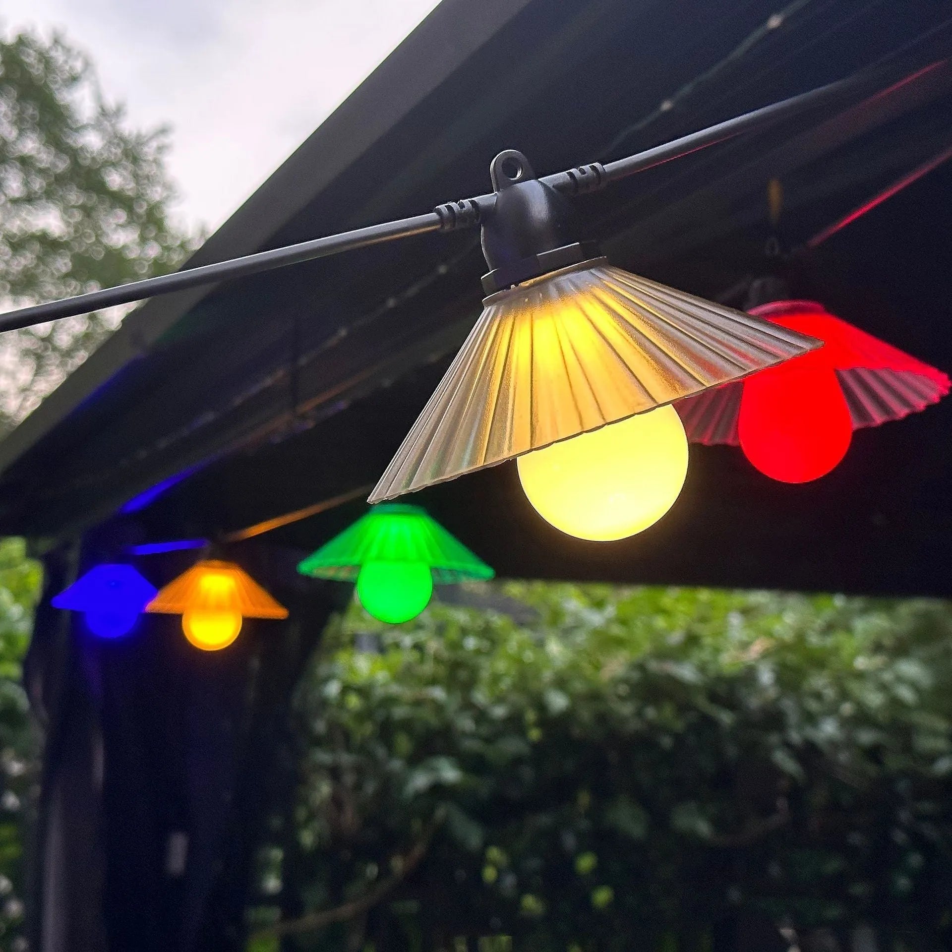 Outdoor LED string lights with flower-shaped globes in various colours including warm white