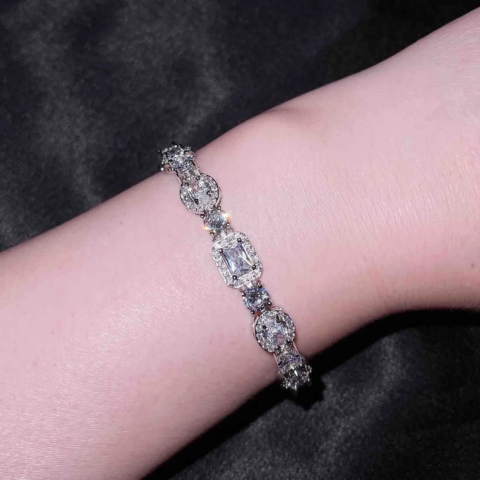 Women's geometric bracelet with silver and white gold plating and sparkling inlaid zircon stones.