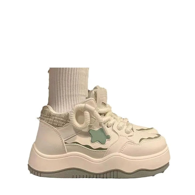 Women's green patent leather platform sneaker with front lace-up design and round toe