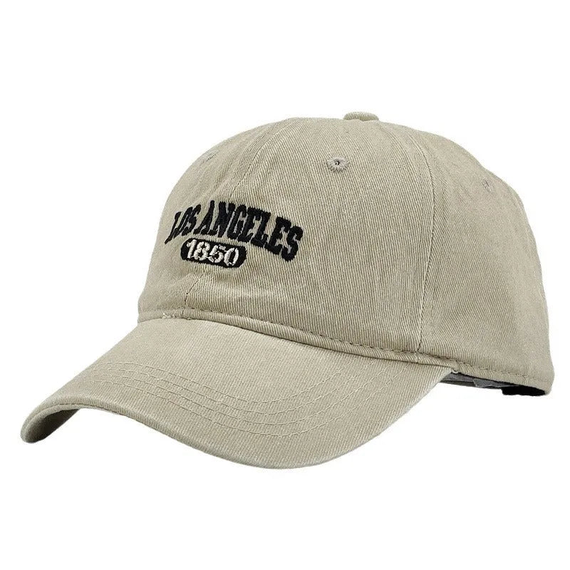 Retro washed distressed embroidered peaked cap with adjustable strap on a conical crown.