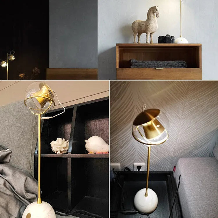 Clear glass desk lamp with dimmable LED light and touch switch on base.