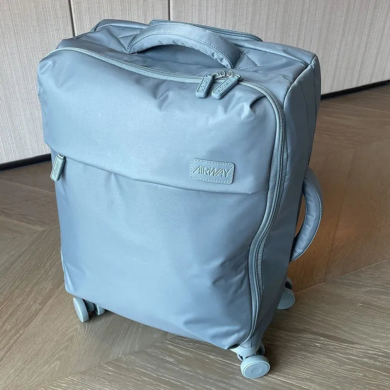 Ultra-light waterproof Oxford cloth suitcase with universal wheels in bluestone green colour.