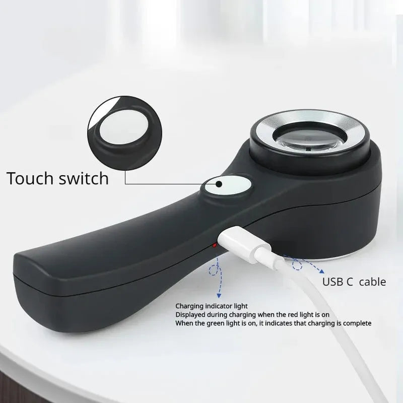 Black and silver metal 30x magnification appraisal magnifying glass with optical glass lens and USB C cable.