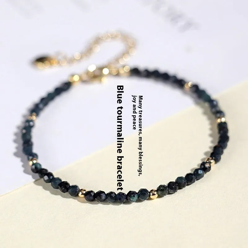 Blue tourmaline spacer bead bracelet with 3mm cut beads and blue gold accents