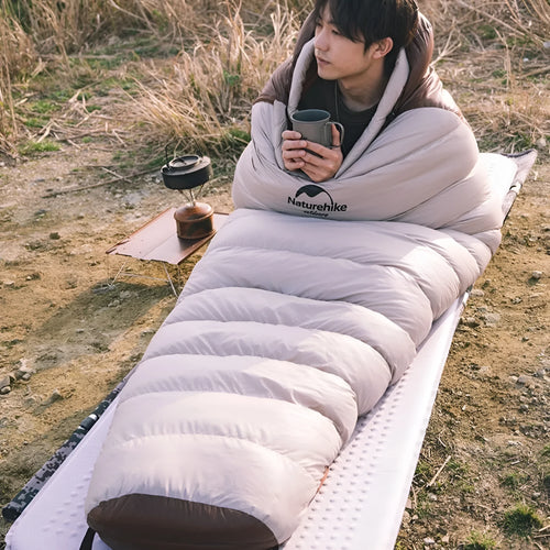 Goose down mummy sleeping bag for adult camping in a stuff sack